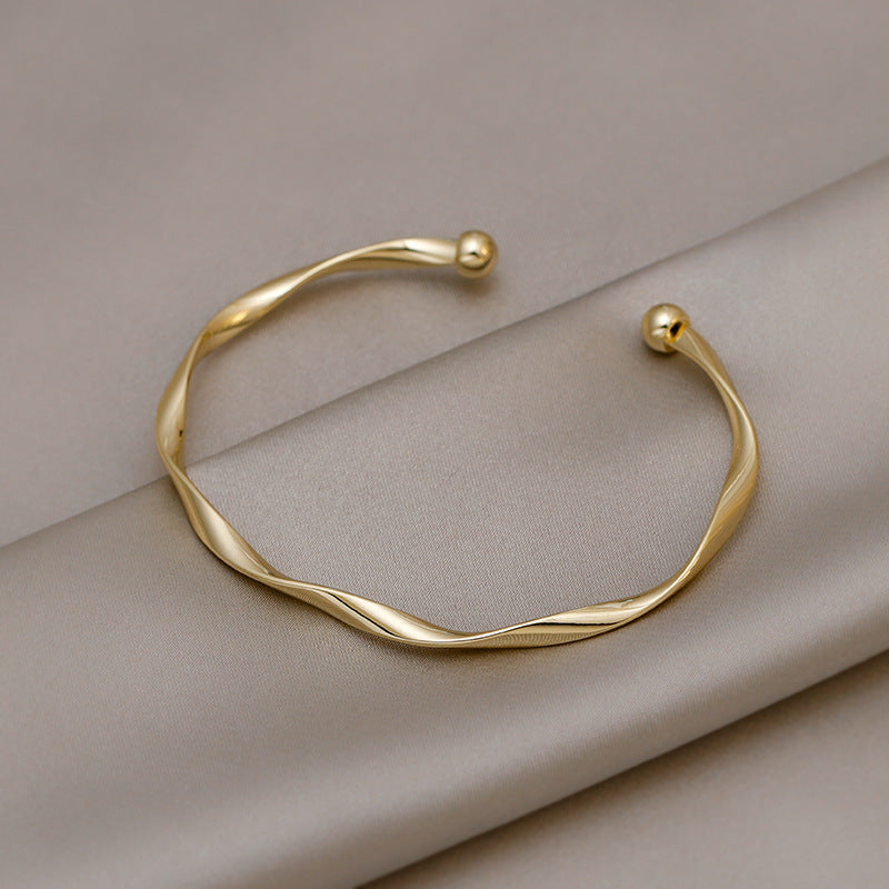 A Sleek And Stylish Twisted Texture Golden Bangle NovaCart