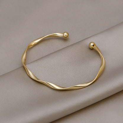 A Sleek And Stylish Twisted Texture Golden Bangle NovaCart