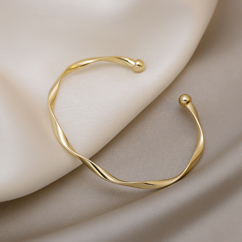 A Sleek And Stylish Twisted Texture Golden Bangle NovaCart