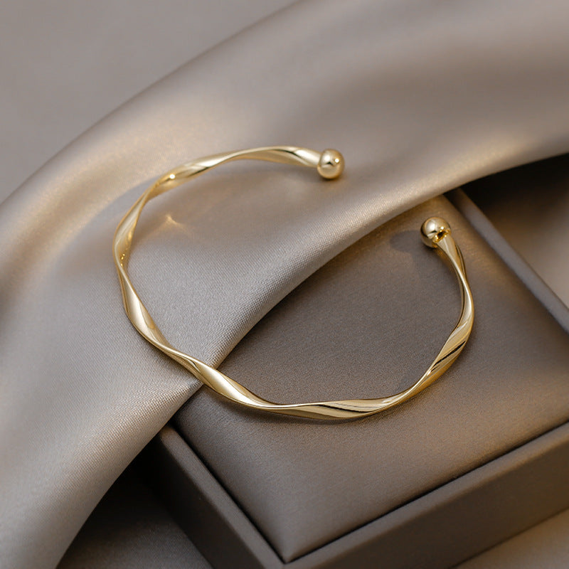 A Sleek And Stylish Twisted Texture Golden Bangle NovaCart