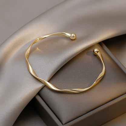 A Sleek And Stylish Twisted Texture Golden Bangle NovaCart