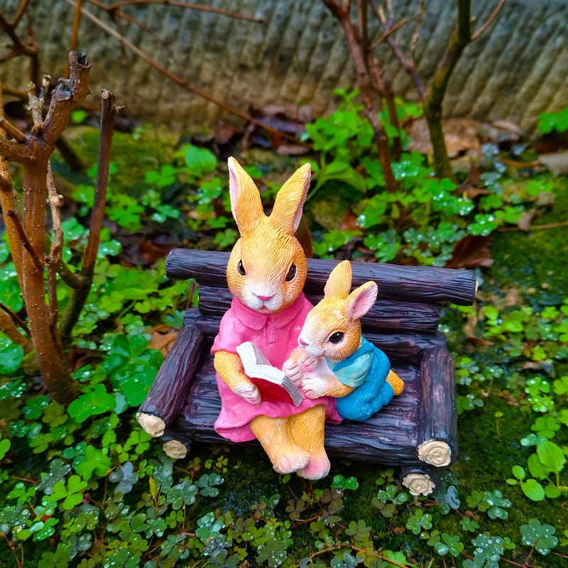 Simulated rabbit reading animal ornament