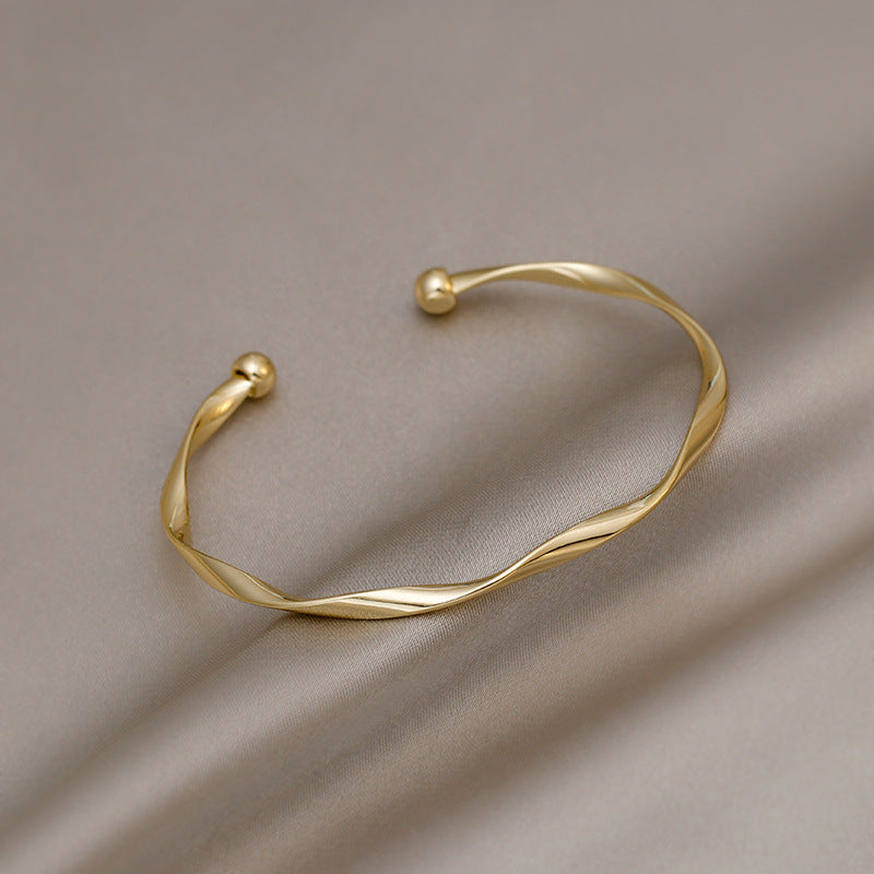 A Sleek And Stylish Twisted Texture Golden Bangle NovaCart
