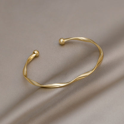 A Sleek And Stylish Twisted Texture Golden Bangle NovaCart